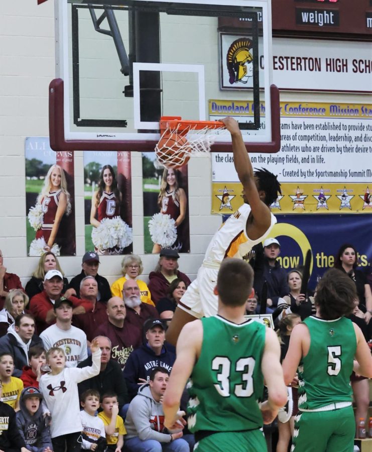 Justin Sims dunks the basketball during the first half of play