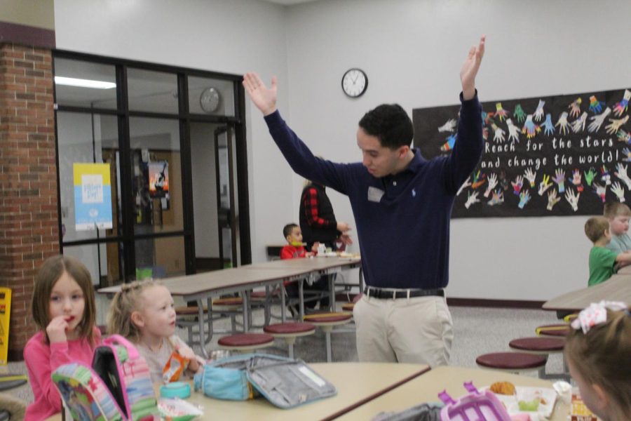 Senior Hamza Sahli shows students at Jackson elementary how to dance to the YMCA.