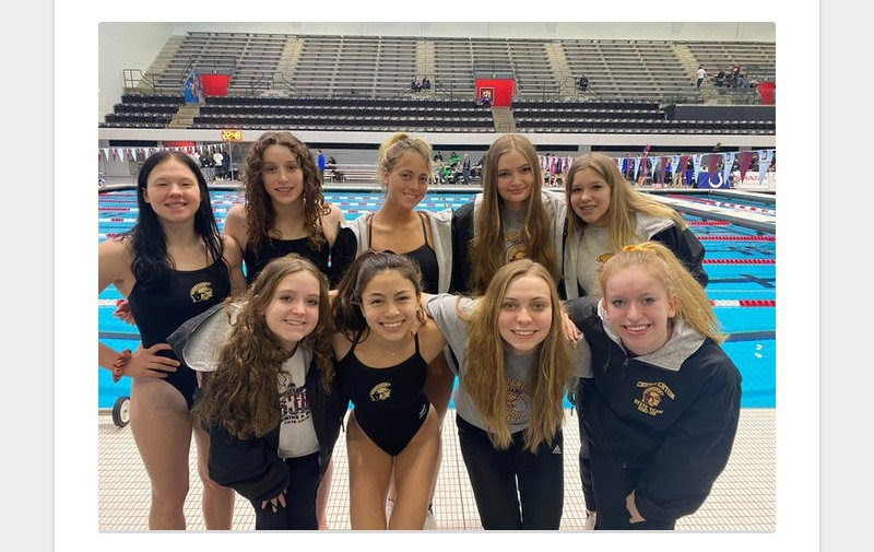 Girls+swim+huddle+up+to+celebrate+after+State+Finals.+