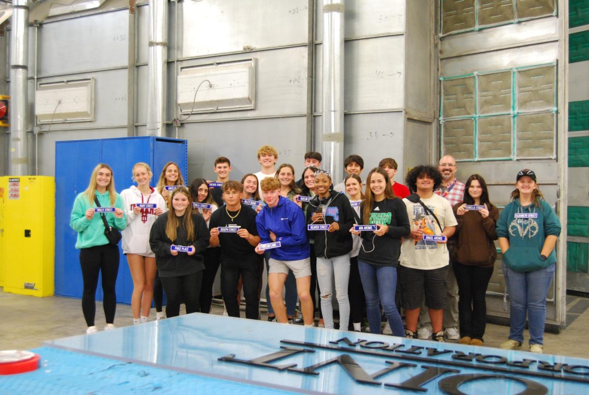 Student's at a previous Sign Day with their signs. Image provided through Legacy Sign Group staff.