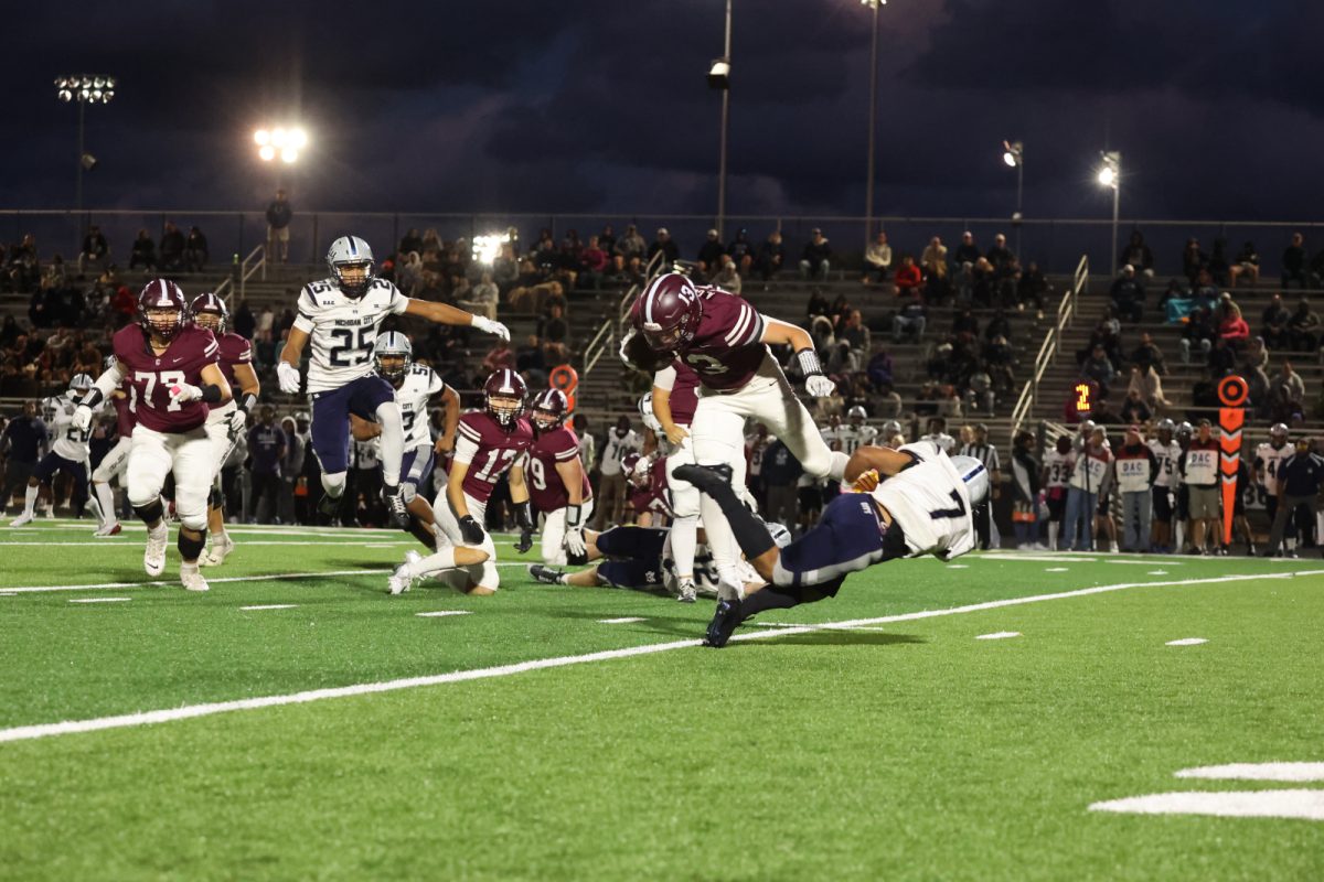 Junior Running back Andrew Goveia avoids a diving opponent on an outside run.