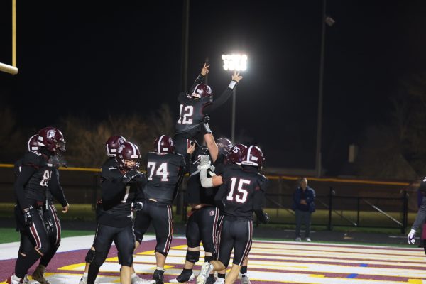 The offense celebrates after a rushing touchdown by senior quarterback CJ Perez.