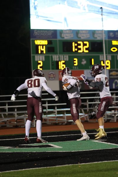 Junior receivers Michael Rone, Louis Raffin, and Patrick Mochen celebrate Raffin's touchdown.