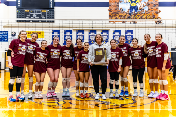 The team celebrates with their sectional  trophy in the Hobart gym.