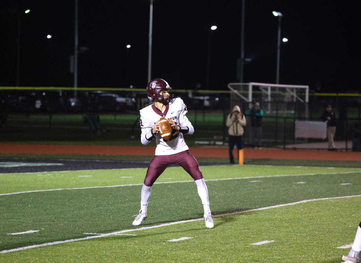 Senior quarterback CJ Perez finishes his drop as he looks for open receivers.